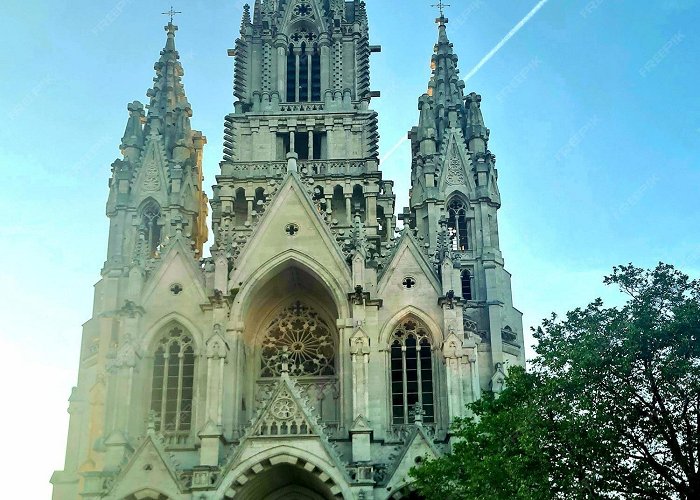 Notre Dame Church of Laken Premium Photo | A church with a plane trail in the sky photo