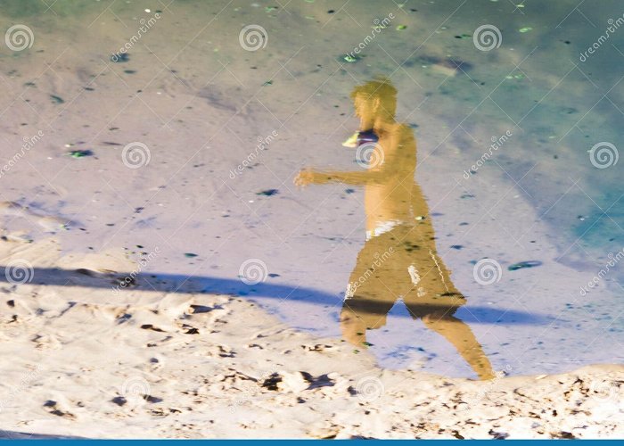 Ondina Beach Reflection of a Person in the Puddle of Water at Ondina Beach ... photo